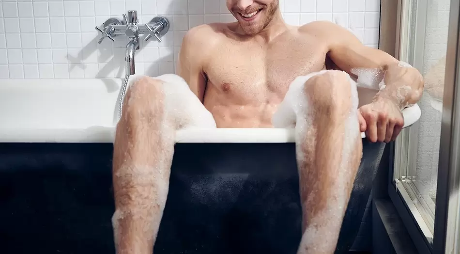 Man takes a bath before G-spot stimulation